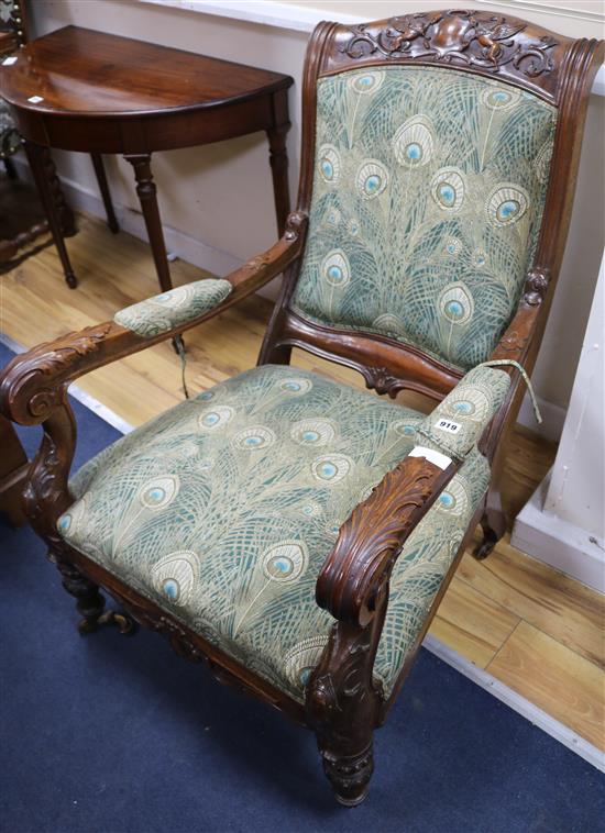 A Victorian mahogany open armchair, carved with griffons flanking a coronet and a vacant cartouche